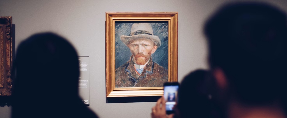 A Van Gogh self-portrait hanging in a museum gallery.