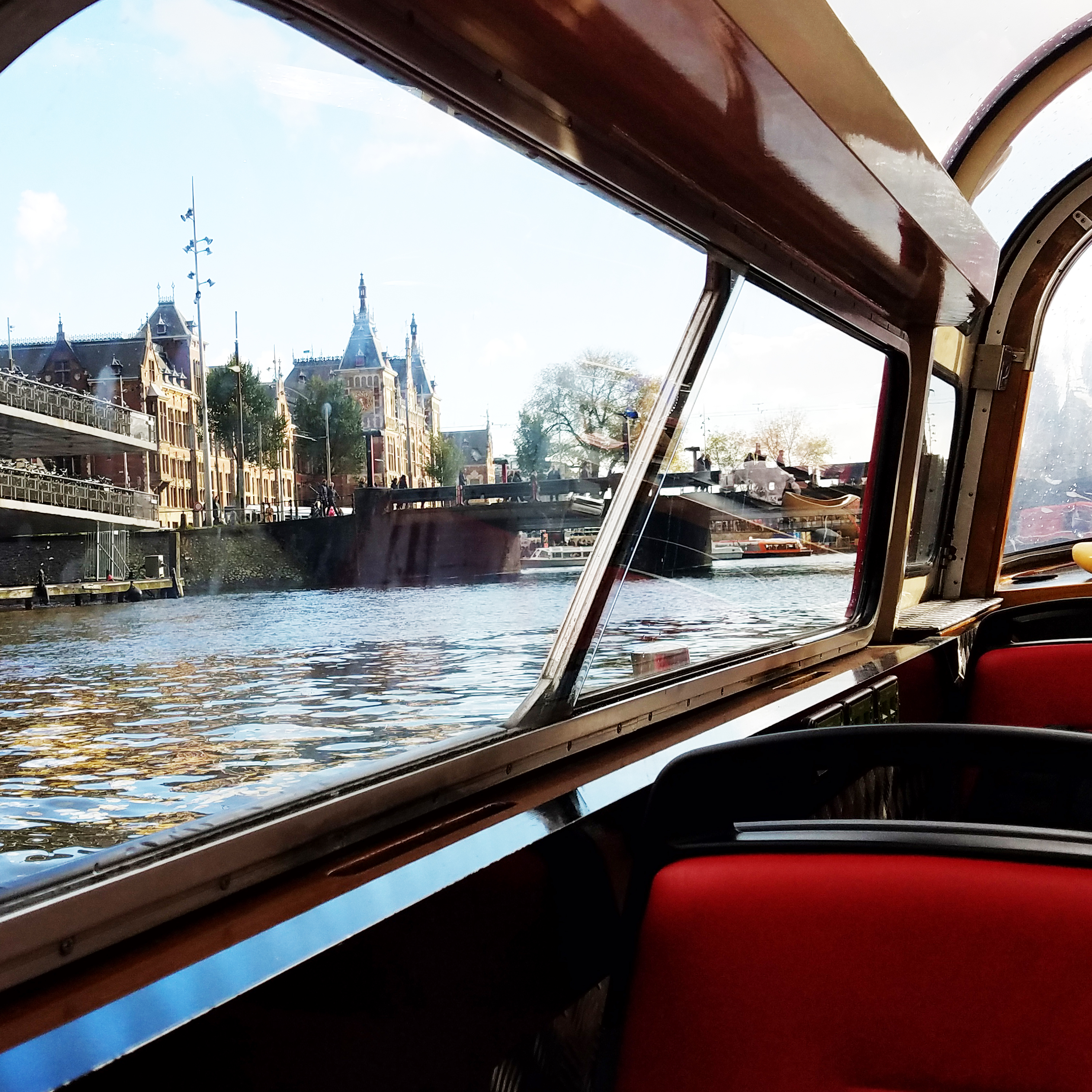 A canal and house-lined street scene in Amsterdam.