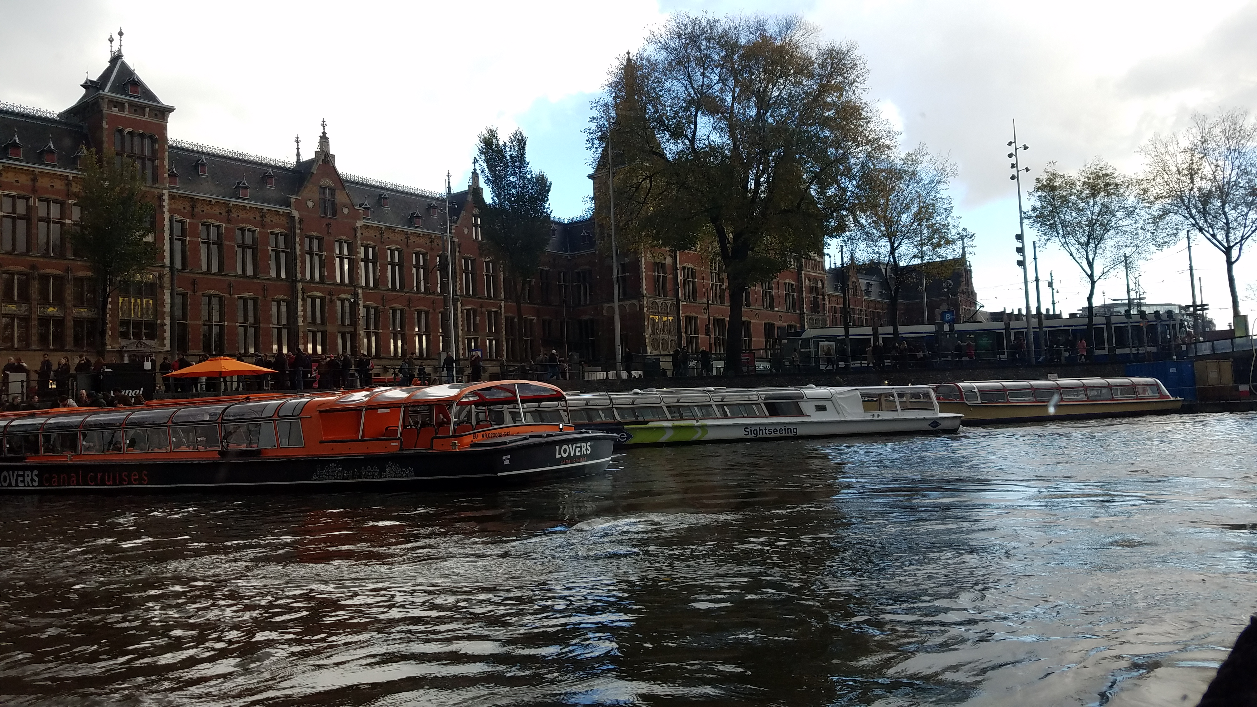 Boats moving along a canal in Amsterdam.