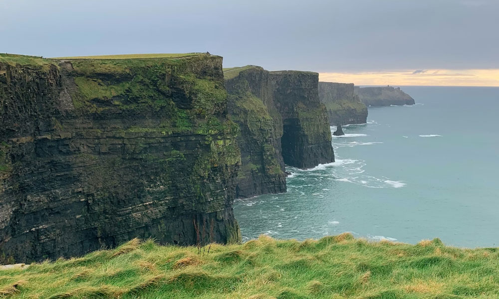 A wide view of the Cliffs of Moher coastline in Ireland.
