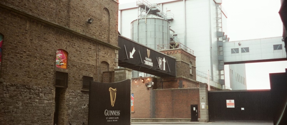 A Guinness sign marks a brick Guinness Storehouse building in Dublin.