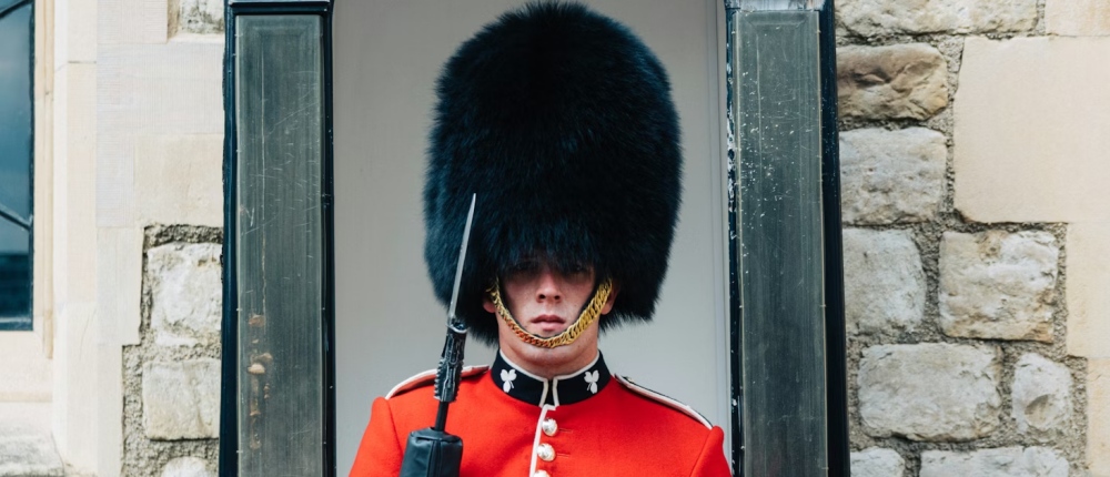 A ceremonial guard in uniform standing on duty in London.
