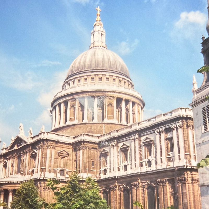 The dome of St. Paul's Cathedral against a blue sky in London.