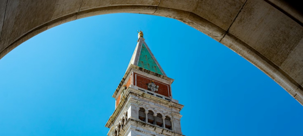 St. Mark's Campanile framed by a stone arch.