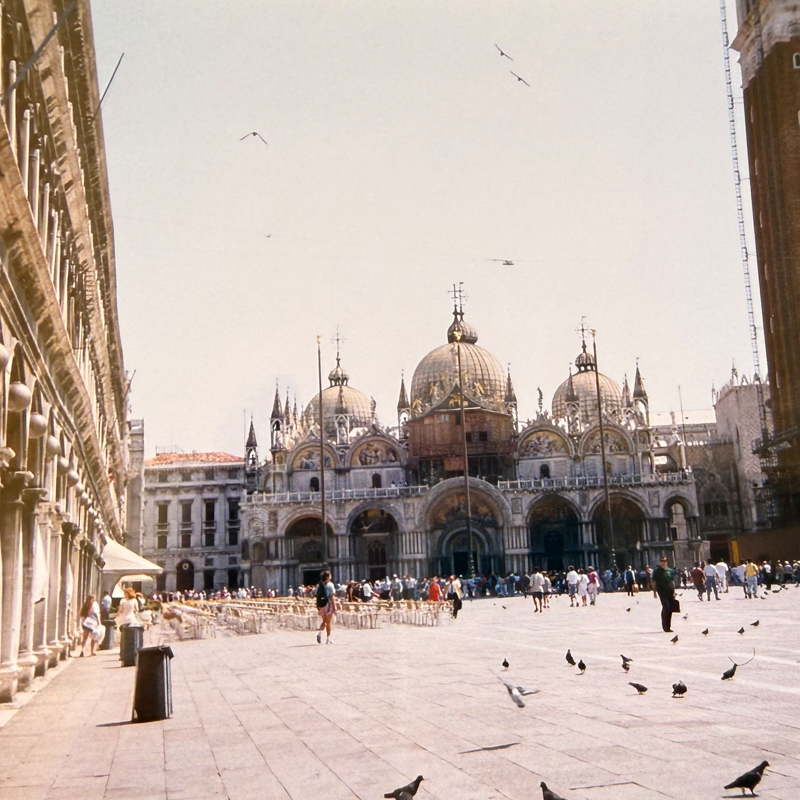 St. Mark's Basilica opening onto a sunlit square in Venice.